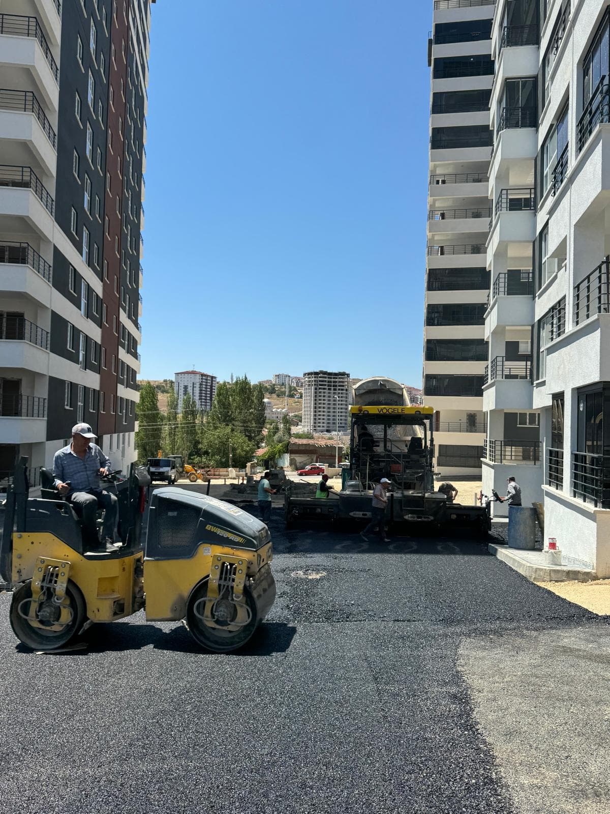 Brn Yol konut sitesi yolunda asfalt serimi, silindir ve Vögele finişer